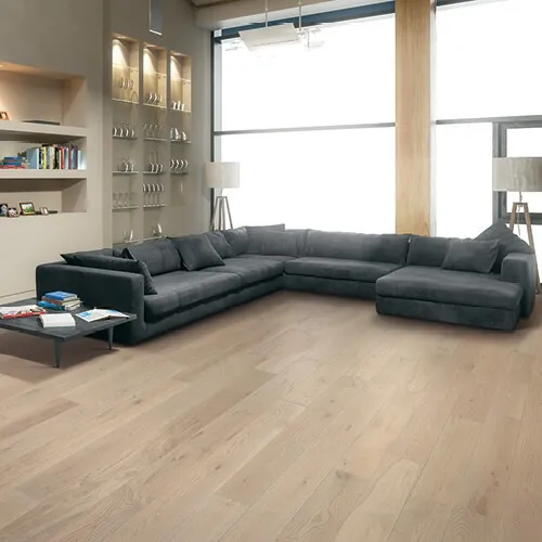 Black sofa on luxury vinyl | I & J Carpets, Inc.